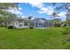 Spacious backyard featuring a screened-in pool and ample green space at 16317 Colwood Dr, Odessa, FL 33556