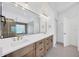 Elegant bathroom boasting double vanity, sleek lighting, and modern shower, designed for ultimate relaxation and style at 16317 Colwood Dr, Odessa, FL 33556