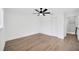 Bright bedroom with wood flooring, ceiling fan, closet, and doorway at 16317 Colwood Dr, Odessa, FL 33556