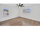 Bright bedroom with wood flooring and multiple windows for natural light at 16317 Colwood Dr, Odessa, FL 33556