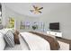 Sun-filled bedroom with ceiling fan, complemented by neutral decor, creates a serene and inviting atmosphere at 16317 Colwood Dr, Odessa, FL 33556