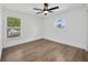 This bright bedroom offers wood flooring and two stylish windows at 16317 Colwood Dr, Odessa, FL 33556