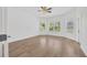Spacious bedroom filled with natural light from multiple windows, featuring sleek flooring at 16317 Colwood Dr, Odessa, FL 33556