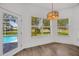 Bright breakfast nook featuring a view of the pool and manicured backyard at 16317 Colwood Dr, Odessa, FL 33556