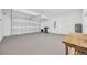 Spacious garage featuring epoxy flooring, storage, water heater and ample room for three vehicles at 16317 Colwood Dr, Odessa, FL 33556