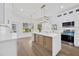 Bright kitchen boasts white cabinetry, a spacious island, modern appliances, and scenic views at 16317 Colwood Dr, Odessa, FL 33556