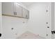 Functional laundry room with overhead cabinets, maximizing space and offering an efficient area for laundry tasks at 16317 Colwood Dr, Odessa, FL 33556