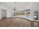 Open living room boasts floor-to-ceiling curved windows and a backyard pool view at 16317 Colwood Dr, Odessa, FL 33556
