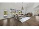 Light and airy living room with stylish furniture and a large curved window offering views of the pool at 16317 Colwood Dr, Odessa, FL 33556