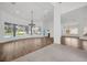 Spacious living room featuring a wall of curved windows providing a view of the backyard and pool at 16317 Colwood Dr, Odessa, FL 33556