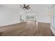 Open-concept living room boasting curved window with backyard view and light wood flooring at 16317 Colwood Dr, Odessa, FL 33556