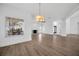 Spacious living room with fireplace, light wood flooring, and large windows with backyard views at 16317 Colwood Dr, Odessa, FL 33556