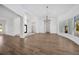 Spacious open-plan living room with high ceilings, modern chandeliers, and light wood flooring at 16317 Colwood Dr, Odessa, FL 33556