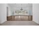 Spacious living room with hardwood floors, curved windows, and views to the backyard and pool at 16317 Colwood Dr, Odessa, FL 33556
