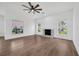 Bright living room featuring light wood floors, fireplace, and large windows at 16317 Colwood Dr, Odessa, FL 33556