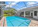 Sparkling swimming pool with screened enclosure and tiled patio, great for outdoor enjoyment at 16317 Colwood Dr, Odessa, FL 33556