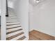 A bright staircase features wood treads with white risers and black handrail at 16317 Colwood Dr, Odessa, FL 33556