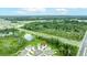 An aerial view of homes situated near a lush green forest, with a pond, highway, and red location pin at 1680 Hazy Sea Dr, Plant City, FL 33565