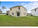 A spacious backyard showing the home's elevation plus a manicured lawn at 1680 Hazy Sea Dr, Plant City, FL 33565