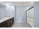 Bathroom featuring double sinks, a walk-in shower, and tile flooring at 1680 Hazy Sea Dr, Plant City, FL 33565
