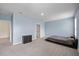 Spacious bedroom with large windows, light blue walls, and a chest of drawers at 1680 Hazy Sea Dr, Plant City, FL 33565