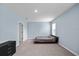 Bedroom with light blue walls, a dark bed frame, and large windows at 1680 Hazy Sea Dr, Plant City, FL 33565