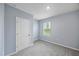 Cozy bedroom featuring gray carpet, light blue walls, and a bright window at 1680 Hazy Sea Dr, Plant City, FL 33565