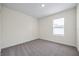 Bright bedroom with neutral carpet, fresh paint, and a window letting in natural light at 1680 Hazy Sea Dr, Plant City, FL 33565