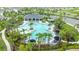 Aerial view showcases resort-style community pool with palm trees, lounge chairs and umbrellas at 1680 Hazy Sea Dr, Plant City, FL 33565