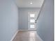 Clean, bright entryway with tile flooring and a modern front door with three glass panels at 1680 Hazy Sea Dr, Plant City, FL 33565