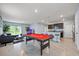Spacious game room with a pool table, living area, and kitchen bar, perfect for entertaining at 1680 Hazy Sea Dr, Plant City, FL 33565