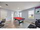 Game room featuring a pool table, bar seating, and a comfortable living area at 1680 Hazy Sea Dr, Plant City, FL 33565