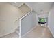 Hallway with carpeted stairs and a glimpse into a game room featuring a pool table at 1680 Hazy Sea Dr, Plant City, FL 33565