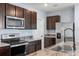 Modern kitchen featuring stainless steel appliances, ample counter space, and sleek dark wood cabinetry at 1680 Hazy Sea Dr, Plant City, FL 33565