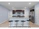 Gourmet kitchen features an island with barstool seating, stainless steel appliances, and granite countertops at 1680 Hazy Sea Dr, Plant City, FL 33565