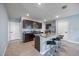 Kitchen island with bar stool seating, granite countertops, stainless steel appliances, and tile flooring at 1680 Hazy Sea Dr, Plant City, FL 33565