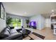 The spacious living room features a modern design, tile flooring, and a patio door at 1680 Hazy Sea Dr, Plant City, FL 33565