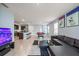 Open-concept living area featuring a kitchen island with bar stools and a seating area with a pool table at 1680 Hazy Sea Dr, Plant City, FL 33565