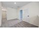 Spacious loft area with gray carpet and doorways to other rooms at 1680 Hazy Sea Dr, Plant City, FL 33565