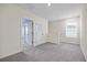 Loft area with a window, gray carpet, and view of other rooms at 1680 Hazy Sea Dr, Plant City, FL 33565