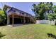 The backyard boasts a spacious yard and mature trees, complemented by the house and upper deck at 1858 Michigan Ne Ave, St Petersburg, FL 33703