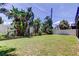 Lush backyard with privacy fence, mature trees, and manicured lawn offers a private outdoor retreat at 1858 Michigan Ne Ave, St Petersburg, FL 33703