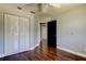 Bedroom featuring hardwood floors, a closet with white doors and black door to another room at 1858 Michigan Ne Ave, St Petersburg, FL 33703