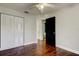 Bedroom featuring hardwood floors, a ceiling fan and a closet with white doors at 1858 Michigan Ne Ave, St Petersburg, FL 33703