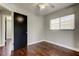 Bedroom with hardwood floors and a black door at 1858 Michigan Ne Ave, St Petersburg, FL 33703