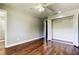 Bedroom featuring wood floors, closet, and a door leading to bathroom with patterned shower at 1858 Michigan Ne Ave, St Petersburg, FL 33703