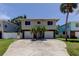 Two-story home featuring a spacious driveway, and complemented by a palm tree at 1858 Michigan Ne Ave, St Petersburg, FL 33703