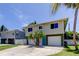 Two-story home featuring a spacious driveway, and complemented by a palm tree at 1858 Michigan Ne Ave, St Petersburg, FL 33703