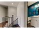 Bright hallway featuring a staircase, leading to a modern bathroom with colorful wall art at 1858 Michigan Ne Ave, St Petersburg, FL 33703