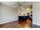 Open-concept kitchen with white cabinets, stainless steel appliances, and hardwood floors at 1858 Michigan Ne Ave, St Petersburg, FL 33703